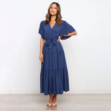 Dark blue midi dress with ruffle skirt and flutter sleeves, featuring a fitted waist and elegant shoulder design, suitable for daytime wear.