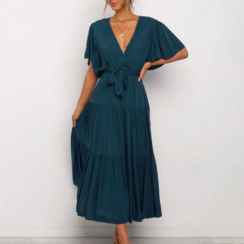 Dark green midi dress featuring a ruffle skirt and flutter sleeves, designed as a one-piece garment with a focus on shoulder, arm, and waist detailing, ideal for day wear. Suitable for size 2XL.