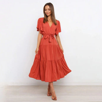 Burnt orange midi dress featuring a ruffle skirt and flutter sleeves, designed with a fitted waist and knee-length cut, suitable for day or formal wear.