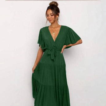 Burnt orange midi dress featuring a ruffle skirt and flutter sleeves, shown in grass green, size 2XL, worn by a model.