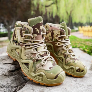 Camouflage tactical hiking boots with military style and high ankle support, shown on a grassy terrain.