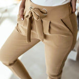Khaki paperbag waist trousers with a tie belt, designed for casual chic style, showcasing a comfortable fit with wide legs and a relaxed silhouette.
