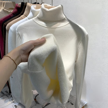 Soft apricot cashmere turtleneck sweater in XL size displayed on a clothes hanger, showcasing its elegant collar and long sleeves, highlighting the luxurious and sophisticated design.