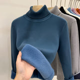 Soft cashmere turtleneck sweater in a light grey color, featuring a high collar and long sleeves, suitable for winter wear.