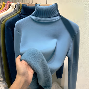 Large blue cashmere turtleneck sweater with long sleeves and a soft, luxurious texture, suitable for winter wear.