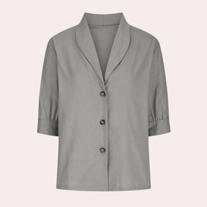 Light gray linen blouse featuring a button-up front, oversized collar, and long sleeves, designed for casual summer wear.