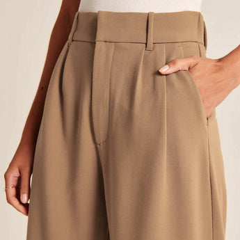 Charcoal gray high waist wide-leg trousers for women with a sleek silhouette and a tailored fit, highlighting the waist and flowing elegantly down the legs.