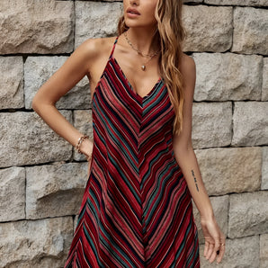 Chevron striped sleeveless V-neck skater dress modeled by a woman with loose hair, showcasing a casual summer fashion look.