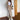 Women's chic beige tracksuit in khaki, size 3XL, featuring a fashionable design with attention to details such as shoulder, waist, and thigh fit. The tracksuit includes a stylish collar and long sleeves, suitable for both loungewear and sportswear. The model is accessorized with sunglasses.