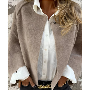 Chic beige wool cape for women featuring a tailored collar and button closure, styled to resemble elegant outerwear with a touch of a blazer or jacket design.