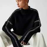 Chic black cut-out sweater for women, showcasing a stylish and modern design with unique cut-out details on the sleeves and neckline, perfect for adding a touch of fashion-forward elegance to any outfit.