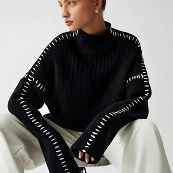 Chic black cut-out sweater for women, showcasing a stylish and modern design with unique cut-out details on the sleeves and neckline, perfect for adding a touch of fashion-forward elegance to any outfit.