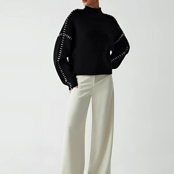 Chic black cut-out sweater for women, featuring a stylish designer knitwear design with distinct cut-outs around the shoulders and neck area, showcasing the upper arms and collarbone area. The long sleeves and slim fit accentuate the waist, offering a modern and elegant look.