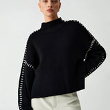 Black cut-out sweater featuring long sleeves and stylish cut-out details, designed for women in a size XL, showcasing a chic and modern look.