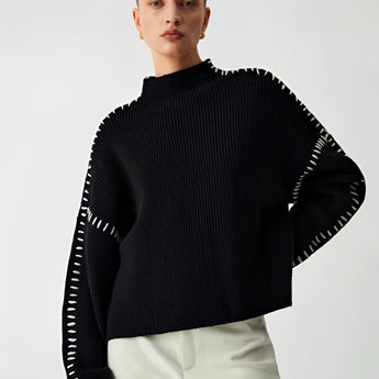 Black cut-out sweater featuring long sleeves and stylish cut-out details, designed for women in a size XL, showcasing a chic and modern look.