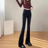 Black velvet flare jeans with a high waist design, styled for winter fashion.