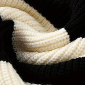 Chic black and white luxury ribbed cotton knit pullover with detailed patterning, showcasing a soft woolen texture.