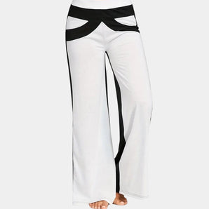 Chic black and white striped bell-bottom yoga pants for women, designed as activewear with a flattering high waist and a flared leg, ideal for sports and casual wear.