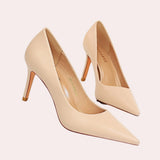 A pair of chic beige women's pointed toe flats displayed on a wooden surface, showcasing their elegant design and court shoe style.