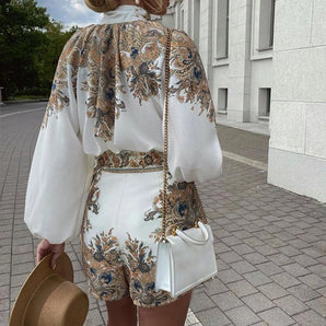 Chic floral balloon sleeve jacket paired with embroidered white shorts, showcasing an elegant fashion design with prominent shoulder and sleeve details.