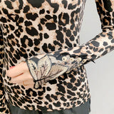 Chic high neck leopard print blouse featuring a back button detail, with long sleeves and a stylish design.