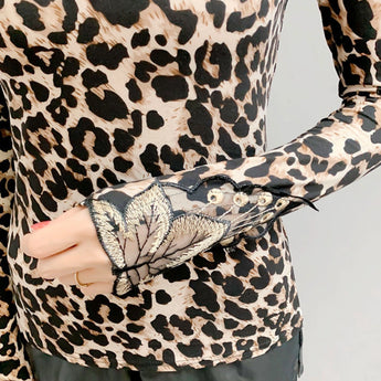 Chic high neck leopard print blouse featuring a back button detail, with long sleeves and a stylish design.