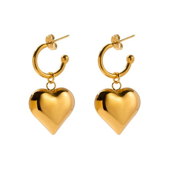 Chic two-tone heart hoop earrings in gold and silver, romantic Valentine's jewelry displayed against a white background.