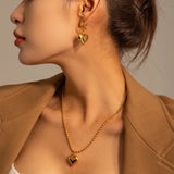 Close-up of a woman wearing Chic Two-Tone Heart Hoop Earrings, showcasing the intricate design and romantic Valentine's jewelry theme.
