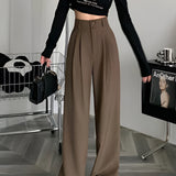 Chic urban women's fashion ensemble featuring a camel-colored wide-leg trousers, cropped tank top, and cardigan in size 2XL.
