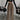Chic urban women's fashion ensemble featuring a camel-colored wide-leg trousers, cropped tank top, and cardigan in size 2XL.