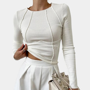 White ribbed twist front crop top blouse with long sleeves, showcased on a model.