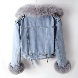 Chic women's light wash denim jacket with a fur-trimmed collar and sleeves, featuring a stylish blend of natural and woolen materials.