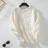 Chunky knit textured beige sweater with long sleeves and a round collar, displayed on a clothes hanger against a light background.