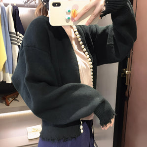 Chunky navy oversized knit cardigan sweater with a distressed hem, featuring long sleeves and a relaxed fit.