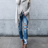 Women's chunky turtleneck sweater paired with taupe ankle boots, featuring a cozy knit design in a winter fashion setting.