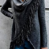 Women's chunky turtleneck sweater in grey paired with taupe ankle boots, showcasing winter knitwear style.