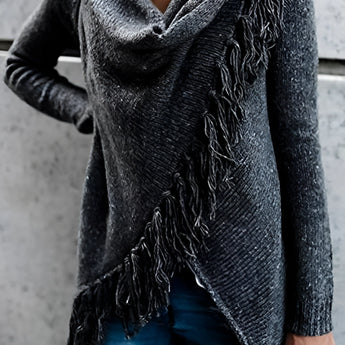 Women's chunky turtleneck sweater in grey paired with taupe ankle boots, showcasing winter knitwear style.