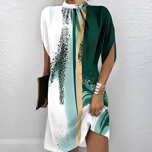 Color-block abstract print dress featuring a combination of green, white, and gold colors, with short sleeves and a round neckline.