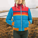 Color-block puffer jacket in luminescence blue, featuring a high collar and insulated design, shown in size 3XL. The jacket is styled with azure accents on the shoulders and sleeves, emphasizing its outerwear functionality and travel-ready appeal.