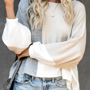 Women's color-blocked sweater styled for casual fall fashion, featuring a chic design with various color panels, worn by a model with a hat, showcasing the sweater's fit and fashionable appeal for the autumn season.