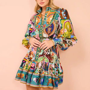 Colorful bohemian animal print mini dress featuring a vibrant and unique design. The dress is a one-piece garment with a flattering waistline, short sleeves, and a stylish neckline, making it perfect for a day out. The model showcases the dress with confidence, highlighting its distinct and lively pattern.