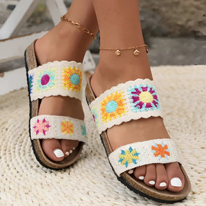 Colorful Bohemian embroidered flat sandals on a person, highlighting intricate embroidery and vibrant colors, perfect for trendy summer footwear.