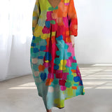 Colorful Bohemian Maxi Dress featuring an abstract print with a V-neckline, designed for summer wear, showcasing a one-piece garment with sleeves and a defined waist.