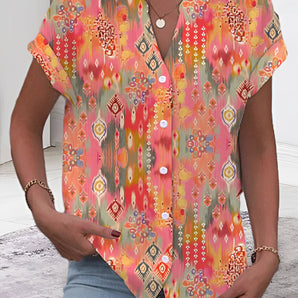 A woman wearing an orange, lightweight, colorful boho blouse with a V-neck, featuring ethnic tribal patterns, suitable for summer, in 3XL size.