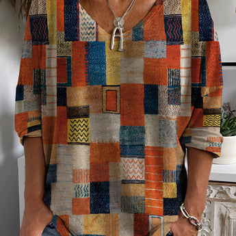 Colorful geometric bohemian V-neck blouse in orange with tribal patterns, featuring a comfortable fit, visible shoulder and sleeve details, suitable for summer fashion.