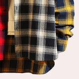 A men's dress shirt featuring a colorful plaid pattern with shades of blue, showcasing a classic collar and long sleeves, designed in a tartan style.