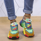 Colorful rainbow sneakers featuring a vibrant multicolor pattern with shades of electric blue, yellow, and magenta, worn on a human foot against a denim background.