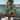 Colorful Retro Print Kaftan in green, 5XL size, featuring a vibrant psychedelic pattern, shown as a beach cover-up with flowing sleeves perfect for summer travel, set against a backdrop of a lake and sky.