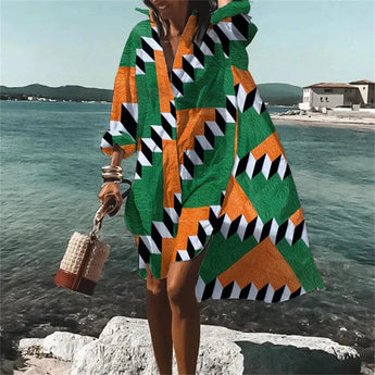 Colorful Retro Print Kaftan in green, 5XL size, featuring a vibrant psychedelic pattern, shown as a beach cover-up with flowing sleeves perfect for summer travel, set against a backdrop of a lake and sky.