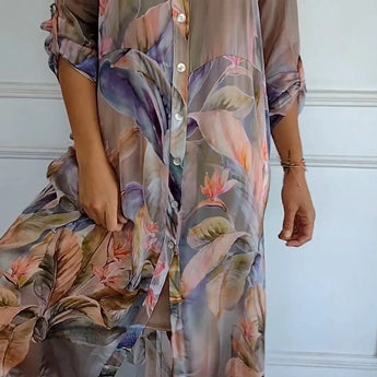 Colorful sheer floral tunic dress in a tropical print, featuring lightweight fabric, suitable for summer. The dress includes a collar, short sleeves, and a defined waist, designed in a 3XL size for a comfortable and stylish fit.